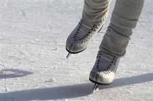 Someones legs with ice skates on